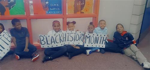 Students Pose with Black History Posters